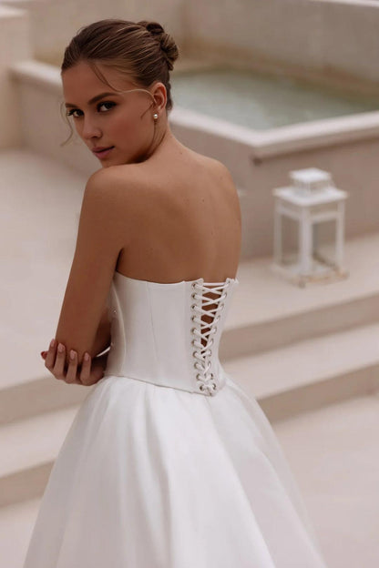 White Strapless Satin Ball Gown Wedding Dress with Long Flowing Train